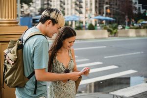 Language tutor helping travelers navigate a city map during a cultural learning experience