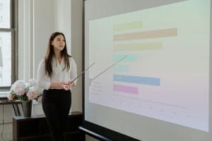 Edtech professional delivering a public speaking presentation with visual aids
